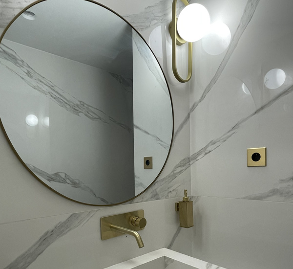 Salle de bain éclairée par une applique murale